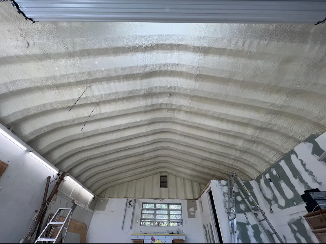 Spray polyurethane foam applied to the underside of a metal roof deck in Irving